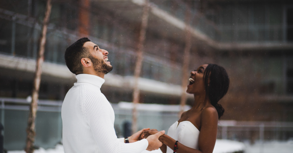 lasting love, couple holding hands, couple laughing, in the snow