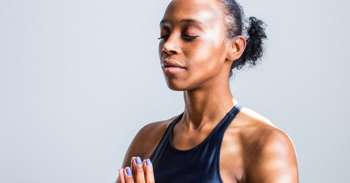 woman with eyes closed and hands joined