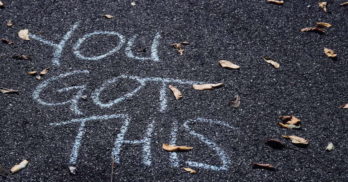 the words "you got this" written in chalk on a road