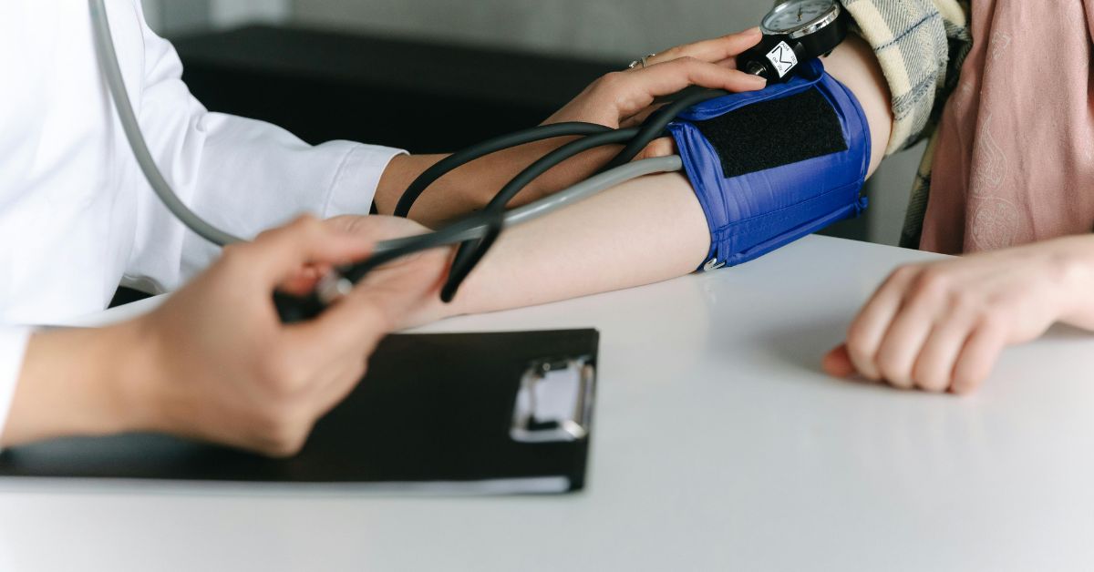 healthcare worker measuring a patient's blood pressure