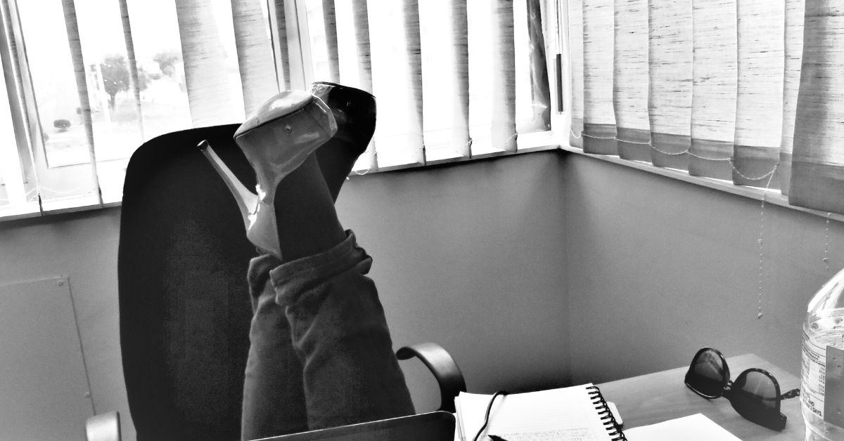 A pair of stilettos in a desk chair at an office